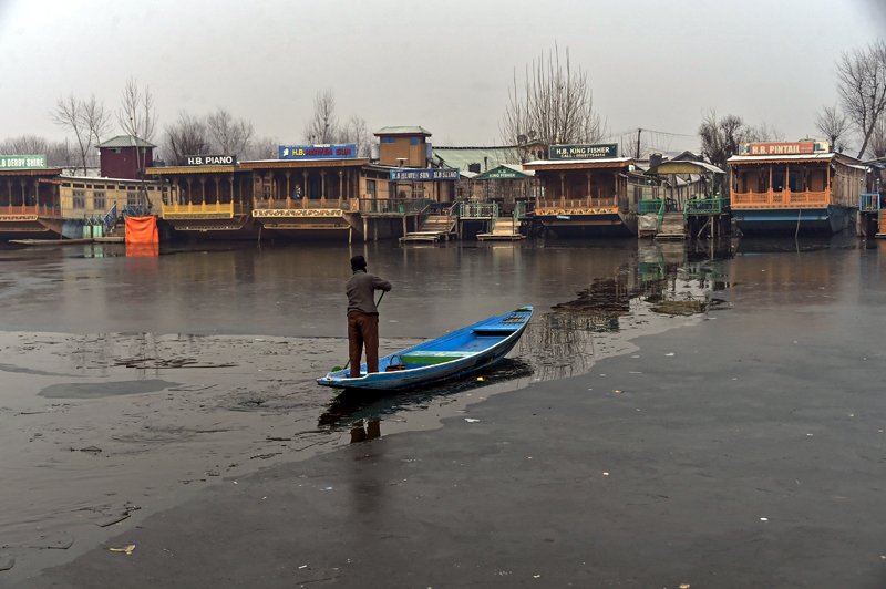 Frames capture scenes of frozen Dal lake in Srinagar on Wednesday morning. -Excelsior/Shakeel