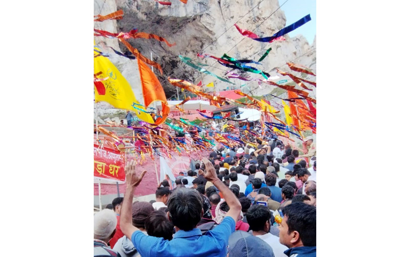 Yatris waiting in long queues at holy cave on Monday.