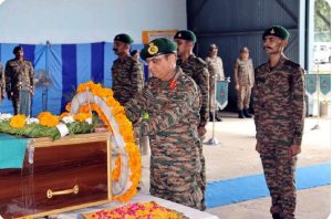 An Army officer pays tribute to martyr Vipan Kumar during the wreath-laying ceremony.
