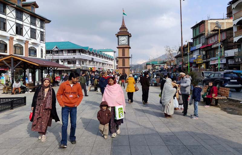 Locals, tourists at Srinagar’s iconic Ghanta Ghar at Lal Chowk as clouds part and sunshine brighten the city on Saturday.-Excelsior/Shakeel